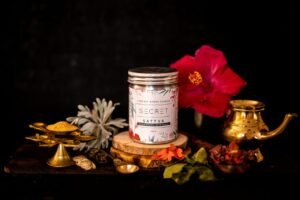 Elegant display of a nourishing hair mask with traditional Indian decor and vibrant flowers.